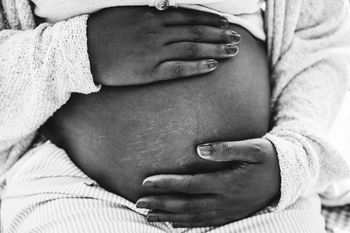 Beautiful black mama showing her baby bump